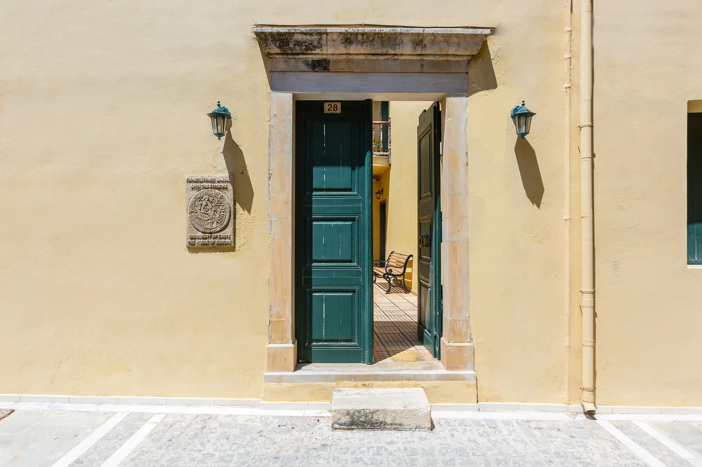 A green Venetian door in a quiet lane of the old town