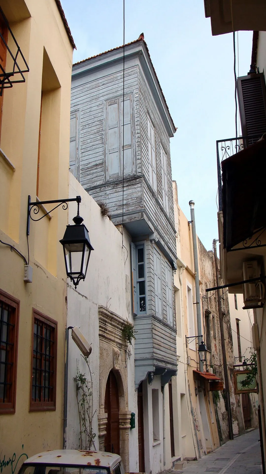 A narrow lane of the old town, wooden Venetian balconies overhead