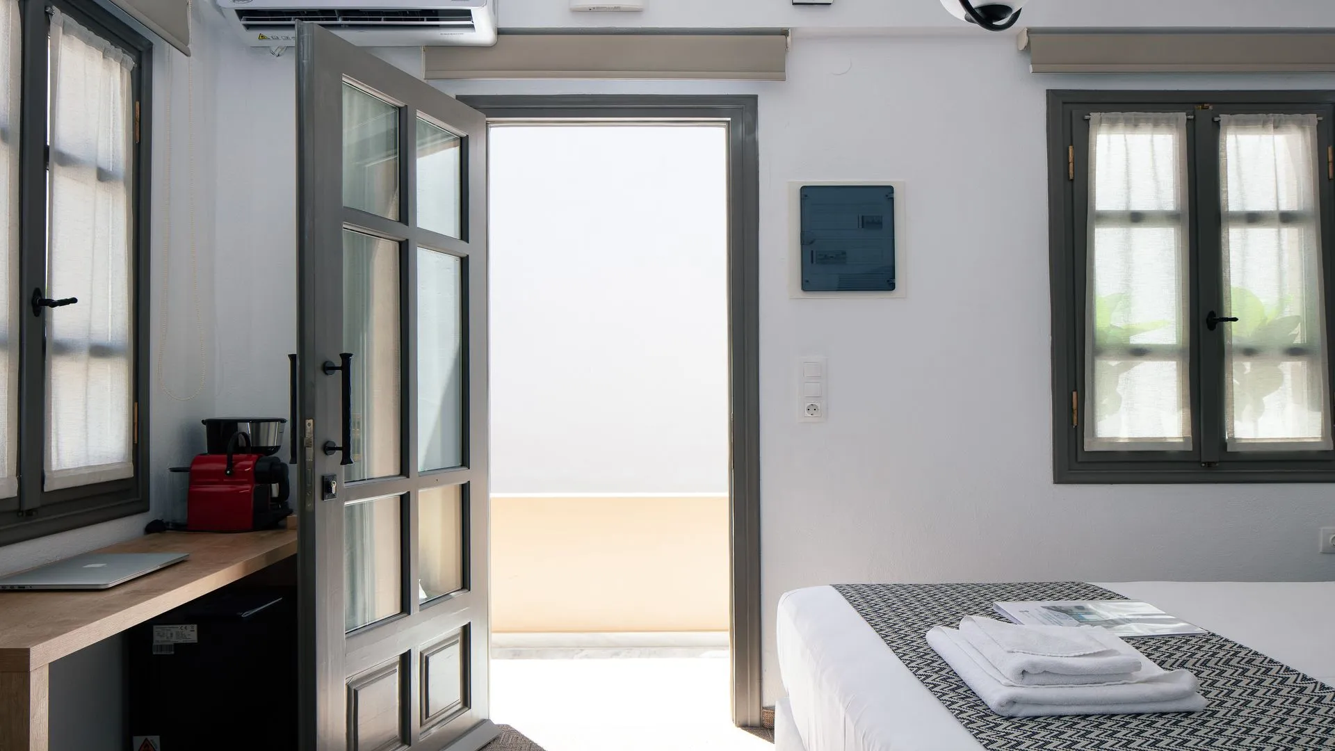An open door onto the light at Ink Hotels, near the reception at Nikolaou Plastira 4